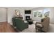 Cozy living room with a fireplace, large windows, and comfortable seating at 841 Pineberry Ct, Grayson, GA 30017