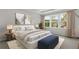 Elegant bedroom with a tray ceiling, large windows, and neutral color scheme at 841 Pineberry Ct, Grayson, GA 30017