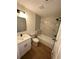 Modern bathroom with new bathtub, white vanity, and contemporary fixtures and marble tiling at 1735 Derry Sw Ave, Atlanta, GA 30310