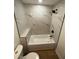 Nicely remodeled bathroom with a soaking tub featuring marble tiling and modern black fixtures at 1735 Derry Sw Ave, Atlanta, GA 30310
