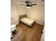 A cozy bedroom with a ceiling fan, hardwood floors, and neutral paint at 1735 Derry Sw Ave, Atlanta, GA 30310