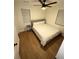 This is a bedroom with hardwood floors, ceiling fan, a large window, and neutral paint at 1735 Derry Sw Ave, Atlanta, GA 30310