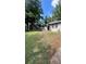 Charming single-story home with manicured lawn and mature trees providing shade and curb appeal at 1735 Derry Sw Ave, Atlanta, GA 30310