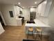 Modern kitchen with white cabinets, stainless steel appliances, and a breakfast bar for casual dining at 1735 Derry Sw Ave, Atlanta, GA 30310
