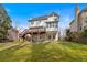 Spacious backyard with a deck and lawn, offering an inviting outdoor living space at the back of the house at 2018 Sugar Maple Ln, Woodstock, GA 30189