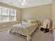 Bright bedroom featuring a decorative white bed frame and ceiling fan at 2018 Sugar Maple Ln, Woodstock, GA 30189
