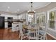 Eat-in kitchen includes a breakfast nook, table, chandelier, and natural light at 2018 Sugar Maple Ln, Woodstock, GA 30189
