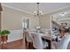 Dining room with hardwood floors, table and chairs, and wainscoting at 2018 Sugar Maple Ln, Woodstock, GA 30189