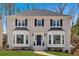 Beautifully maintained two-story home features a classic design and manicured front yard at 2018 Sugar Maple Ln, Woodstock, GA 30189