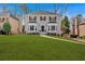 Traditional two-story home featuring black shutters, bay windows, and a lush green lawn at 2018 Sugar Maple Ln, Woodstock, GA 30189