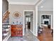 Inviting foyer showcasing tile floors, wooden staircase, and an open view to the living area at 2018 Sugar Maple Ln, Woodstock, GA 30189