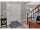 Bright entryway with tile flooring, a stairway, and white trim accents at 2018 Sugar Maple Ln, Woodstock, GA 30189