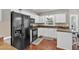 Updated kitchen with white cabinets, black appliances, and hardwood floors at 2018 Sugar Maple Ln, Woodstock, GA 30189