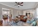 Bright living room boasts hardwood floors, ceiling fan, and an open layout at 2018 Sugar Maple Ln, Woodstock, GA 30189