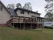 Back exterior featuring a large deck and patio area, perfect for outdoor entertaining and relaxation at 3015 Ascot Ln, Roswell, GA 30076