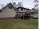 Exterior view of the home showcasing a large backyard, deck, and screened-in porch at 3015 Ascot Ln, Roswell, GA 30076