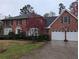 Charming brick home with a two-car garage, black shutters, a green door, and a well-manicured front yard at 3015 Ascot Ln, Roswell, GA 30076