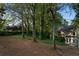 Expansive backyard features mature trees and space for outdoor activities at 3851 Westwick Nw Way, Kennesaw, GA 30152