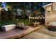 Backyard patio with ambient lighting, lounge chairs, and dining space for relaxing evenings at 3851 Westwick Nw Way, Kennesaw, GA 30152