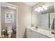 Well-lit bathroom with white cabinets and a shower and toilet in the background at 3851 Westwick Nw Way, Kennesaw, GA 30152