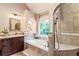 Elegant bathroom showcasing a luxurious tub, vanity with drawers, a mirror and separate shower area at 3851 Westwick Nw Way, Kennesaw, GA 30152