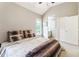 Bright bedroom featuring a comfortable bed with decorative pillows and a well-lit en suite bathroom at 3851 Westwick Nw Way, Kennesaw, GA 30152