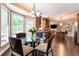 Bright breakfast nook features a glass table set, large windows offering views, and seamless access to the kitchen and living areas at 3851 Westwick Nw Way, Kennesaw, GA 30152