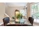 Cozy breakfast nook featuring a glass table, chair set, adjacent windows and a custom waterfall feature at 3851 Westwick Nw Way, Kennesaw, GA 30152