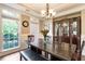 Formal dining room featuring wainscotting, a decorative china cabinet, decorative lighting, and large windows for ample natural light at 3851 Westwick Nw Way, Kennesaw, GA 30152