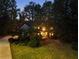 Beautiful exterior elevation of a home with manicured lawn and landscape lighting at 3851 Westwick Nw Way, Kennesaw, GA 30152