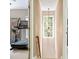 Neutral-toned hallway leading to a workout room, featuring modern lighting and clean finishes at 3851 Westwick Nw Way, Kennesaw, GA 30152