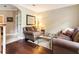 Inviting living room featuring comfortable seating, a glass top coffee table, neutral decor, and seamless access to the rest of the home at 3851 Westwick Nw Way, Kennesaw, GA 30152