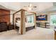 This spacious main bedroom features a beam ceiling, neutral carpet, a canopy bed, and large windows at 3851 Westwick Nw Way, Kennesaw, GA 30152