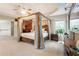 This main bedroom features a beam ceiling, carpet, and a canopy bed, creating a relaxing retreat at 3851 Westwick Nw Way, Kennesaw, GA 30152