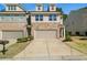 Attractive townhome with stone accents, a two-car garage, and well-maintained landscaping at 372 Mulberry Se Row, Atlanta, GA 30354