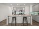 Well lit kitchen island featuring bar stool seating and updated stainless steel appliances at 372 Mulberry Se Row, Atlanta, GA 30354