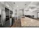 Kitchen island featuring granite countertops, pendant lighting, and stainless steel appliances at 372 Mulberry Se Row, Atlanta, GA 30354
