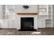 Elegant living room featuring a fireplace, built-in shelves, and hardwood floors at 372 Mulberry Se Row, Atlanta, GA 30354