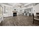 Open-concept living space with a fireplace, built-in shelves, a modern kitchen, and hardwood floors at 372 Mulberry Se Row, Atlanta, GA 30354