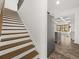 Open staircase leading to the upper level, adjacent to the kitchen and stainless steel refrigerator at 372 Mulberry Se Row, Atlanta, GA 30354