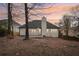 View of the home's backyard featuring a well-maintained lawn and a wooden deck at 4554 Alaspair Ln, Acworth, GA 30101