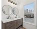 Bathroom featuring a double vanity with marble countertop and views of the outdoors at 4554 Alaspair Ln, Acworth, GA 30101
