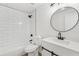 Bathroom with subway tiles, modern fixtures, and a round mirror at 4554 Alaspair Ln, Acworth, GA 30101