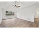 Bright bedroom featuring wood-look floors, a ceiling fan, and plenty of natural light at 4554 Alaspair Ln, Acworth, GA 30101