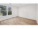 Bedroom featuring hardwood floors and a window with a wooded view at 4554 Alaspair Ln, Acworth, GA 30101