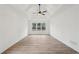 Spacious bedroom with natural light, tray ceiling, ceiling fan and wood-look flooring at 4554 Alaspair Ln, Acworth, GA 30101
