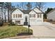 Charming two-story home with white brick and wood-accented shutters and manicured lawn at 4554 Alaspair Ln, Acworth, GA 30101