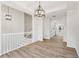 Open-concept hallway leads to a modern kitchen with white cabinets and stainless appliances at 4554 Alaspair Ln, Acworth, GA 30101