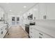 Modern kitchen featuring white cabinets, quartz countertops, stainless appliances, and wood-look floors at 4554 Alaspair Ln, Acworth, GA 30101