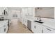 Bright kitchen featuring white cabinets, stainless appliances, quartz countertops and view to living area at 4554 Alaspair Ln, Acworth, GA 30101